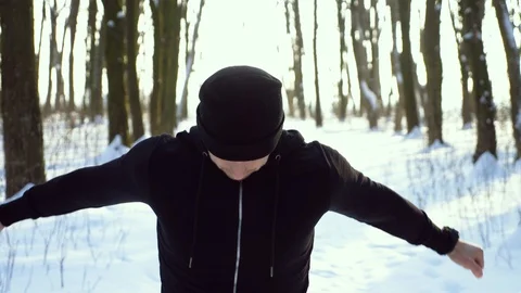 Young attractive man jogger warming up before running outdoors in winter park Stock Footage 87920246