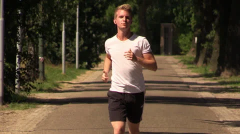 Young attractive man jogging Stock Footage 25787737