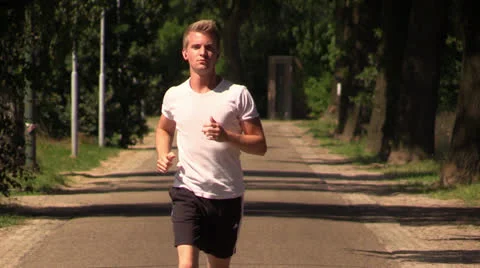 Young attractive man jogging Stock Footage 25787748