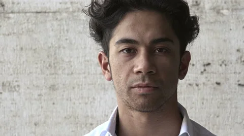 Young attractive man looking at camera having a serious look isolated portrait  Vídeo Stock 66672342