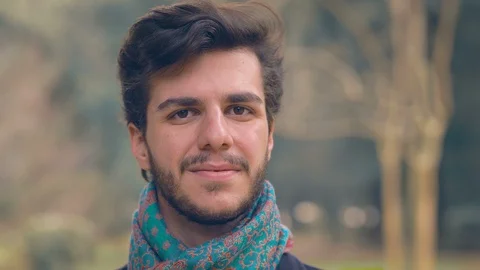 Young attractive man looking at camera and smiling Video stock 121402442