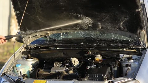 Young attractive man perfusing with water his silver car Stock Footage 89286116