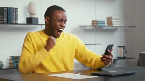Young attractive man received good news on the internet. A successful man reacts Stock Footage 171669939