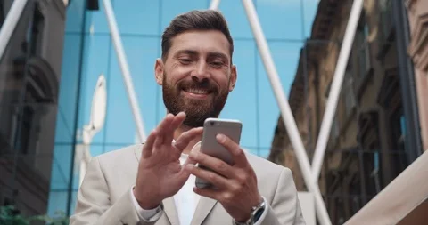 Young Attractive Man Standing in front of Camera by the Glass Building. Stock Footage 122680680