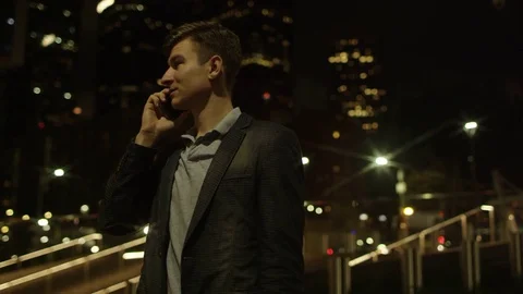 Young attractive man is talking over his smartphone and taking a selfie Stock Footage 77784833