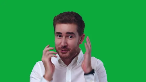 A Young Attractive Man Talks and Acts to the Camera on Green Screen Stock Footage 251946587