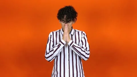 Young attractive man thinking. Orange background. Stock Footage 291983379