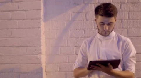 Young attractive man using tablet computer. Stock Footage 66456589