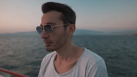 Young attractive man is winking under sunglasses. Handsome and cool guy. Stock-Footage 112934973