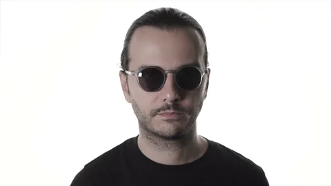 Young attractive man is winking under sunglasses. Handsome and cool guy. Stock Footage 135975887