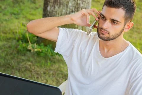 Young attractive man working with computer outdoors Stock-Fotos