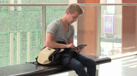 Young attractive man working on iPad Stock Footage 25786643