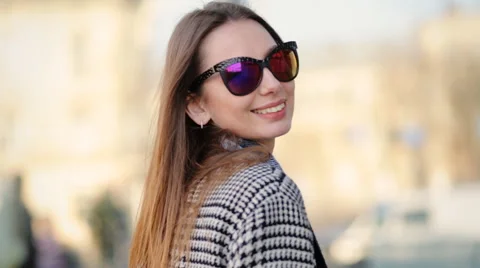 Young attractive model in funny sunglasses professionally posing on camera Stock Footage 61833439