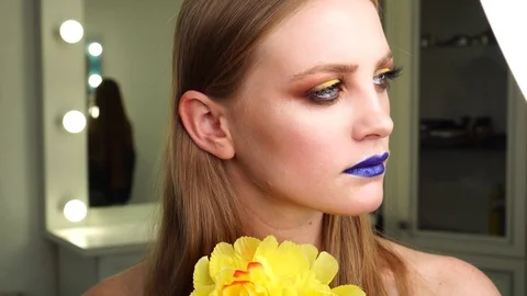 Young attractive model wearing professional artistic makeup bright colored Stock Footage 102735768