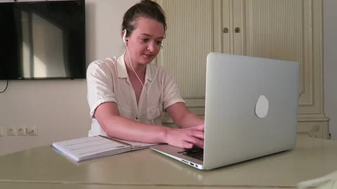 Young, attractive professional woman doing freelance work online at home. Stock Footage