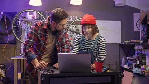 Young attractive professional worker of modern workshop buying parts for bike Stock Footage 232867306