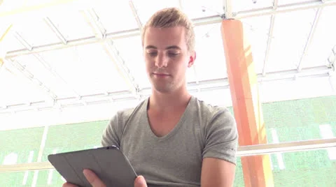Young attractive student on iPad Stock Footage 25786679