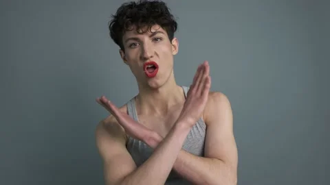 Young attractive trans man with makeup saying NO while crossing his hands Stock Footage 145815050