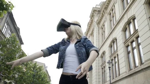 Young attractive woman dancing ballet in public place with virtual reality vr Stock Footage