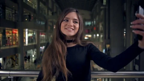 Young attractive woman making a selfie in the shop slow motion Stock Footage