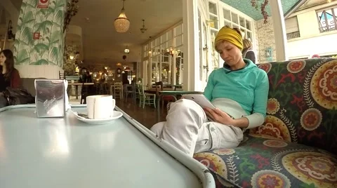 Young attractive woman with tablet computer sitting in cafe Stock Footage 48469549