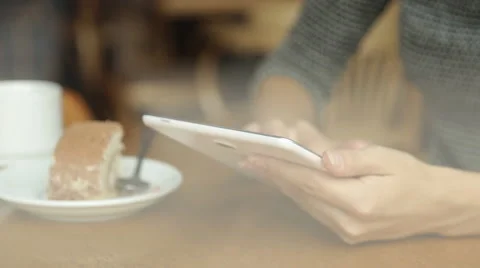 Young attractive woman with tablet computer sitting in cafe Stock Footage 67512909