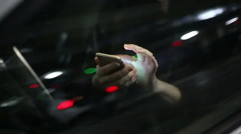 Young attractive woman using mobile phone in the car at underground parking Stock Footage 47745341