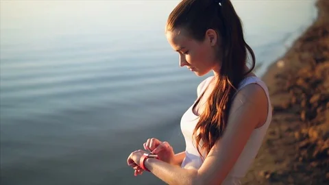 Young attractive woman using touchscreen smart watches. Stock Footage 77487156