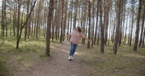 Young attractive woman walking smiling having fun in a summer forest Stock Footage 132946953