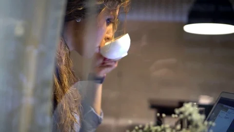 Young attractive woman work in cafe with notebook and drinking tea Stock Footage 78305841