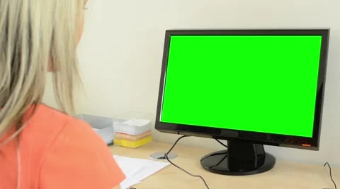 Young attractive woman working on desktop computer in office - green screen Stock Footage