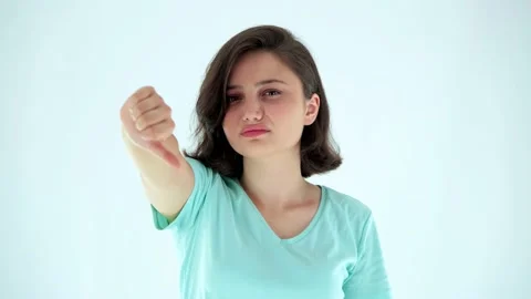 Young attractive womand looking at camera and showing thumbs down. Stock Footage 136003621