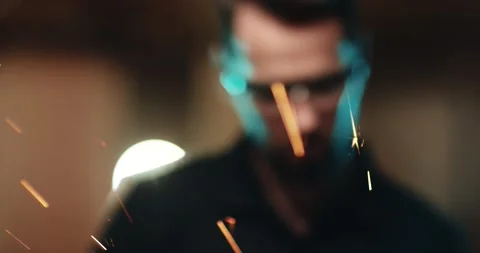 A young attractive worker in protective glasses, processes the metal surface of Video stock 167370317