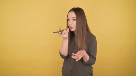 Young attractive young long-haired woman listens and records voice message 4K Stock Footage 149787911
