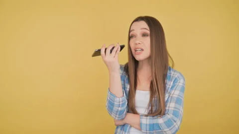 Young attractive young long-haired woman listens and records voice message 4K Stock Footage 149788806