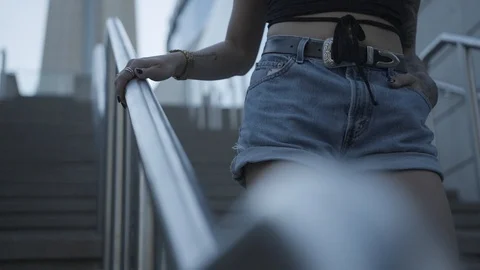 Young Attrative female walking down steps outside slowmotion Stock Footage 85636879