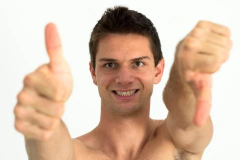 Young attrective man doing thumb up and other thumb down Stock Photos