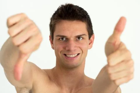 Young attrective man doing thumb up and other thumb down Foto stock