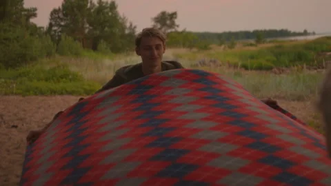Young authentic couple sets up picnic blanket Stock Footage 168095906