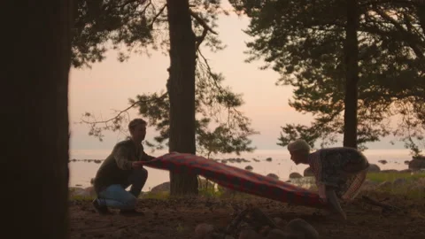 Young authentic couple sets up picnic blanket 動画素材 168909083