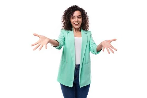 Young authentic curly brunette assistant woman dressed in a blue jacket on a Stock Photos