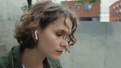 Young authentic woman insert ear buds for music Stock Footage 170264438