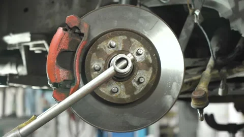 Young auto mechanic repairs an old car. wheel bearing installation. Video stock 211811090