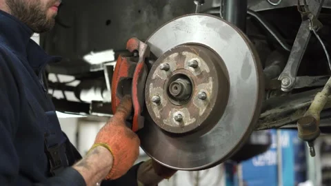 Young auto mechanic repairs an old car. brake system installation. Stock Footage 212604307