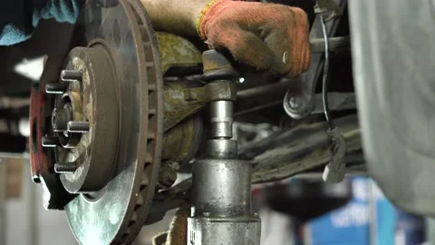 Young auto mechanic repairs an old car. car suspension assembly. close-up Stock-Footage 215786160