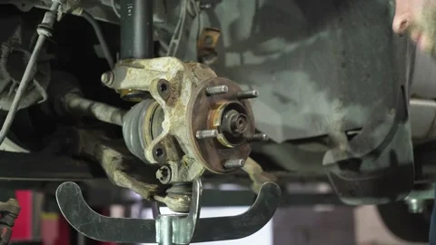 Young auto mechanic repairs an old car. dismantling of old parts. Video stock 215786947