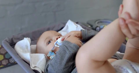 Young baby getting nappy changed Stock Footage 112949968