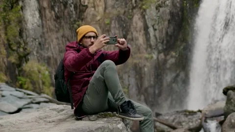 Young Backpack Hiker Guy Sitting Alone on Ridge Stones Freedom Lifestyle Concept Stock Footage 263093146