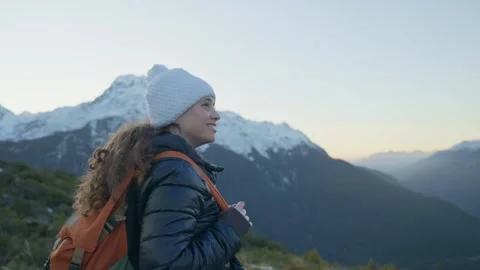 Young backpack hiker reaching summit of mountain looking at beautiful view Stock Footage 289417234