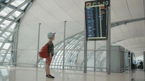 Young backpacker checking flight information on digital schedule display Stock Footage 104603635